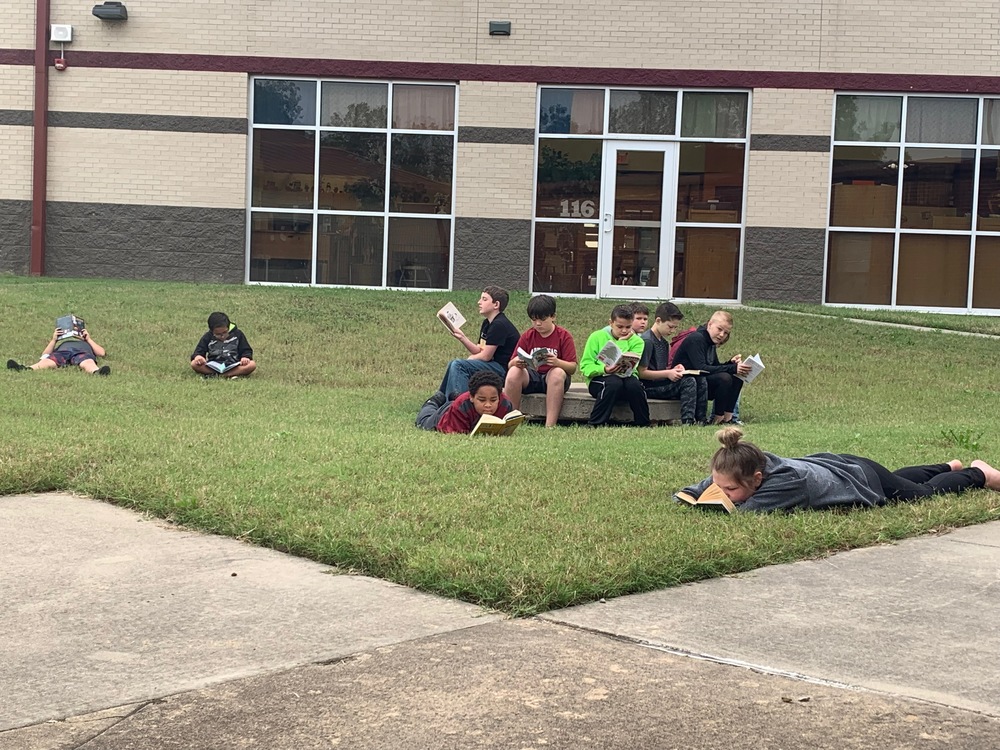 Mrs. Carter's class says, "Happiness is reading outside on a crisp fall morning."
